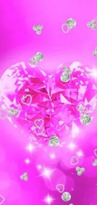 This live wallpaper features a heart-shaped design made out of shimmering diamonds set against a pink background