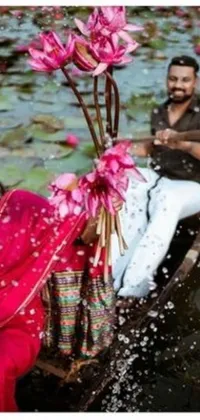 This stunning live wallpaper depicts a romantic moment between a couple in a boat surrounded by pink flowers