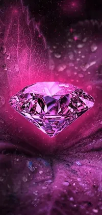 This stunning live wallpaper features a pink diamond resting atop a purple cloth