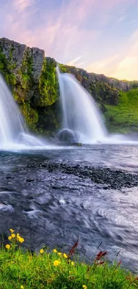 This stunning phone live wallpaper features a magnificent waterfall in a lush green valley