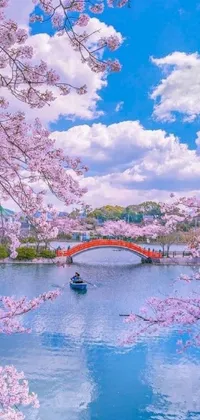 This live wallpaper showcases a serene scene of a boat floating on a river next to a bridge, set against a backdrop of blossoming cherry trees