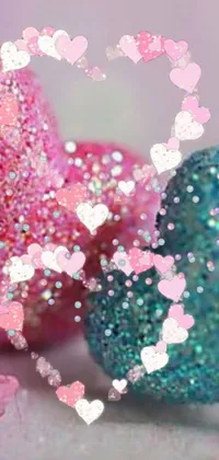 This live wallpaper offers a stunning design featuring glitter hearts scattered on a table in a cute teal and pink color scheme