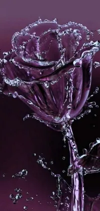 This stunning phone live wallpaper features a beautiful purple rose that is lightly covered in sparkling water droplets