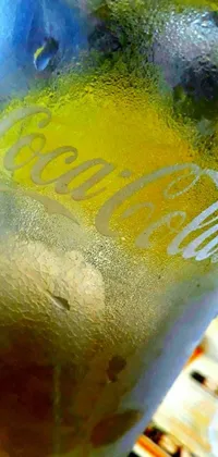 This phone live wallpaper features a bubbly glass of soda on a colorful, graffiti-inspired table