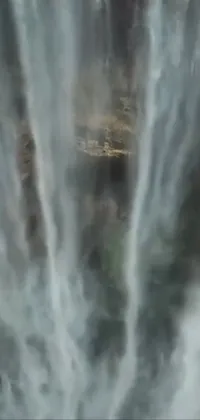 Transform your phone into a peaceful oasis with our live wallpaper featuring a majestic waterfall