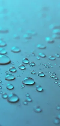 This stunning phone live wallpaper showcases a close-up macro photograph of water droplets on a surface, featuring a light blue background