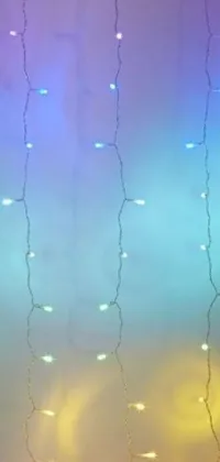 This live wallpaper features colorful lights flickering on a wall against a rainbow stripe backdrop with opalescent mist