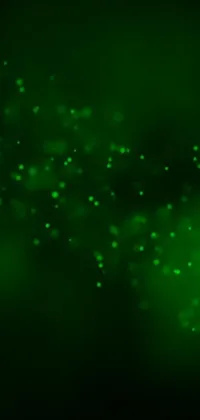 This phone live wallpaper boasts a striking close-up of a green glowing light against a dark background with floating particles and a star-filled sky
