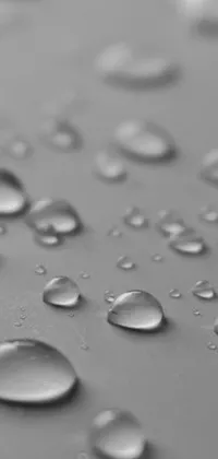 This phone live wallpaper showcases a stunning close-up of water droplets on a surface in a sleek and waterproof design