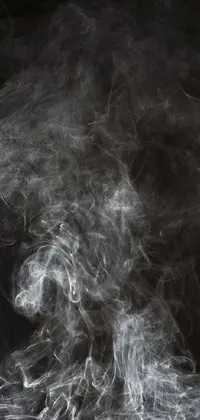 This live wallpaper for your phone features a close-up of smoke on a black background with trailing white vapor
