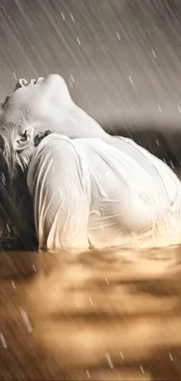 This live wallpaper features a stunning photorealistic painting of a woman lying on her stomach in serene water
