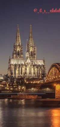 This phone live wallpaper features a high quality depiction of a breathtaking cathedral by a river with a bridge