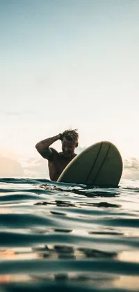 Looking for an exciting live wallpaper for your phone? Look no further than this stunning artwork featuring a male surfer riding the waves of a tranquil body of water