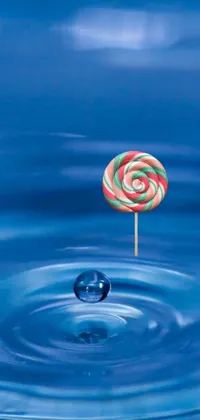 Elevate the look of your phone with this fun live wallpaper featuring a colorful lollipop floating in clear water