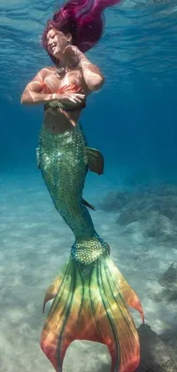 This lovely phone live wallpaper features a mermaid swimming under the water in a stunning underwater world