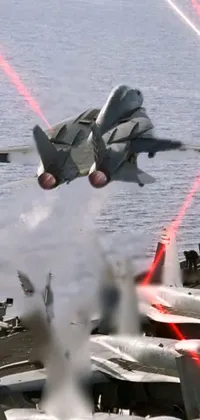 This live wallpaper showcases a fighter jet taking off from an aircraft carrier
