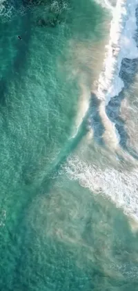 If you're looking for a stunning and dynamic live wallpaper to add to your phone, look no further than this breathtaking aerial view of an ocean scene