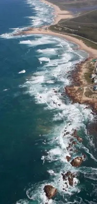 This live wallpaper displays a mesmerizing view of the South African coast, featuring a wide body of water and a lively beach