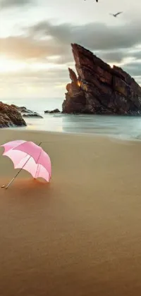 Looking for a stunning phone live wallpaper? Check out this romantic and dreamy pink umbrella resting on a sandy beach