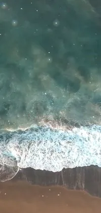 Transform your phone into a tropical paradise with this stunning live wallpaper! Featuring a skilled surfer gliding effortlessly across rolling waves on a vibrant board, set against the backdrop of a serene beach in Bali, this aerial shot captured by a drone will take your breath away