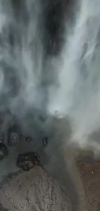 This live wallpaper for your phone showcases a stunning scene of a fiery red fire hydrant unleashing a gush of water high into the sky