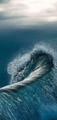 Looking for an awe-inspiring live wallpaper for your phone? Look no further! This amazing wallpaper features a breathtaking scene of a man riding a surfboard on top of a massive wave