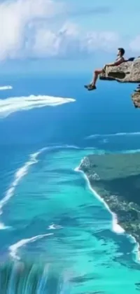 This stunning phone live wallpaper showcases an awe-inspiring scene of a man perched on the edge of a cliff overlooking the vibrant ocean