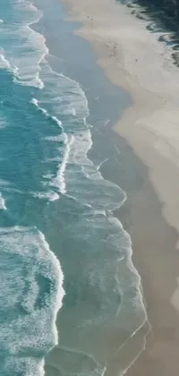 Enjoy a stunning live wallpaper on your phone, featuring an amazing water and beach scene