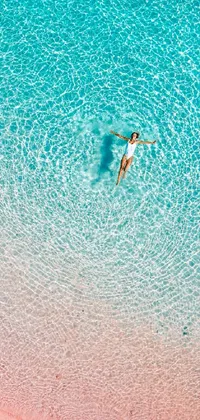 Enjoy a serene live wallpaper for your phone with a graceful floating woman in clear blue water