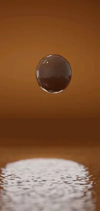 This live wallpaper captures an intricate visual of a water droplet on a table's surface, set amidst the striking orange of Mars