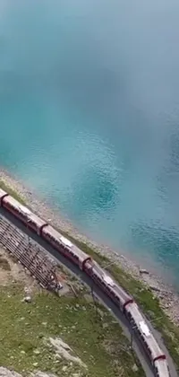 This stunning phone live wallpaper depicts a massive train on a steel track making its way through the Swiss Alps