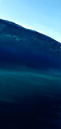 This phone live wallpaper features a stunning digital art creation showcasing a skilled surfer riding a wave on their surfboard