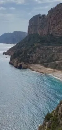 Experience a stunning and dynamic live wallpaper on your phone, featuring a train winding along a mountain beside the ocean