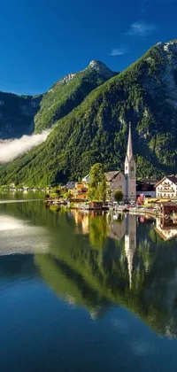 This phone live wallpaper showcases a breathtaking panoramic view of a serene body of water surrounded by mountains in the beautiful small town of Austria