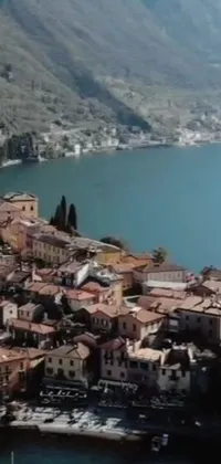 This phone live wallpaper showcases an aerial view of a charming town next to a body of water