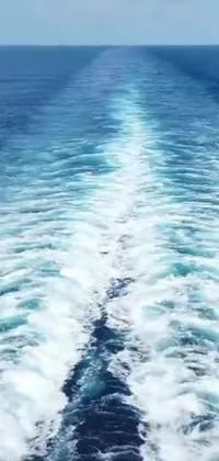 This phone live wallpaper showcases an invigorating view of the ocean from the back of a moving boat