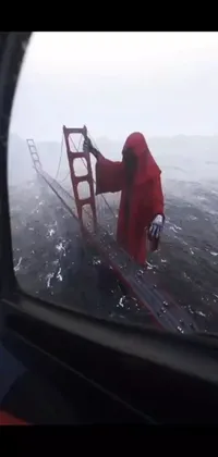 This stunning live wallpaper features a red-robed figure crossing a bridge during a storm captured from a boat