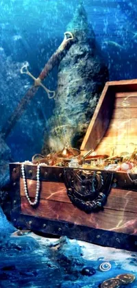 This live phone wallpaper portrays a wooden chest crammed with glittering gold and jewels, resting on an underwater background