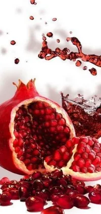 This live phone wallpaper features a beautifully crafted pomegranate with a stunning splash of water