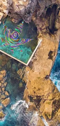 This stunning live wallpaper features an aerial view of a sparkling turquoise swimming pool surrounded by grey rocks