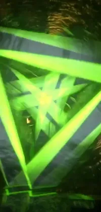 This stunning live wallpaper for your phone boasts a green star-shaped hologram inspired by video art and triangles