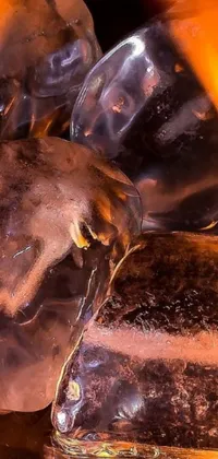 This live wallpaper features a pile of ice on a table with sausages cooking on the fire