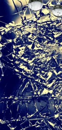 This mesmerizing live wallpaper features broken glass atop a table with a microscopic photo and abstract gold and indigo splashes in a Pollock-inspired style