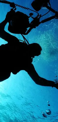 This live wallpaper depicts a mesmerizing underwater scene featuring a deep-sea diver with a camera in hand