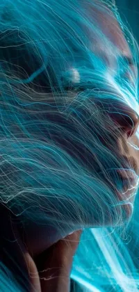 This phone live wallpaper features a close up of a face with flowing hair and glowing cyan dimensional lighting
