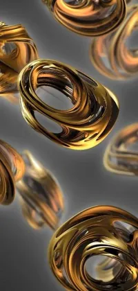 This phone live wallpaper features a group of gold rings floating on top of each other, creating a mesmerizing effect on the screen