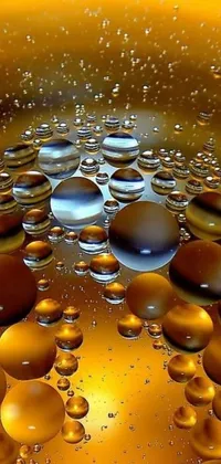 This stunning live wallpaper features a macro photograph of small water bubbles on a surface, with a digital art touch by Jon Coffelt, available at Pixabay