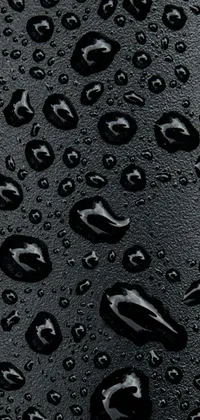 This live wallpaper features water droplets on a patent leather surface, creating a glossy and reflective effect that is both sleek and modern