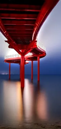 This live wallpaper features a breathtaking image of a red bridge spanning a serene body of water in the Red Sea