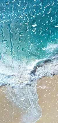 This phone live wallpaper boasts a breathtaking view of a turquoise ocean and sandy beach